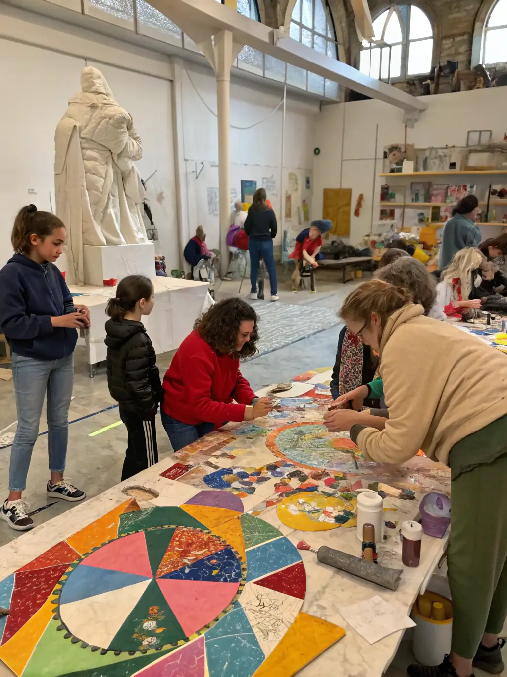 A vibrant photograph capturing participants engaged in a community art workshop, showcasing diverse age groups and artistic expressions, set in a brightly lit studio with colorful art supplies.